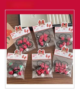 Detail view of 6-piece red polka dot hair ties set for kids featuring rabbits and stars