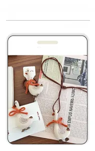 Detail of handmade fabric cartoon duck hair tie with a knitted orange bow on wood surface