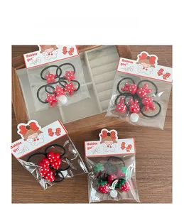 Detailed view of red polka dot hair ties with stars and rabbits on display cards