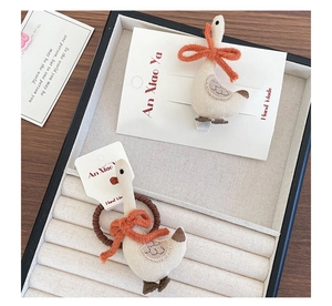 Detailed macro view of handmade fabric goose hair clip set with embroidered texture details