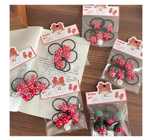 Detail of red polka dot heart and star hair ties for girls on a wooden background