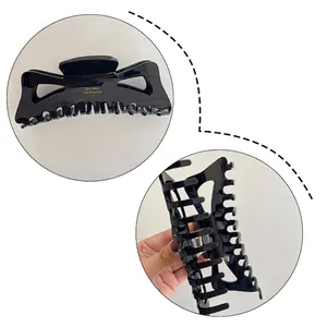 Large black acetate hair claw clip with gold lettering for thick hair styling
