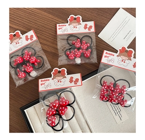 Detailed view of red polka dot bunny hair ties set with resin charms in cute packaging