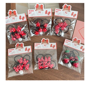 Detail of 6-piece red polka dot hair ties set with rabbit, star and bow shapes