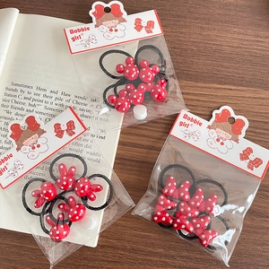 Three red polka dot hair ties for girls featuring bunny and bow resin charms