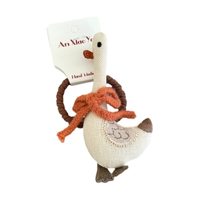 Handmade goose fabric hair scrunchie with orange bow on white card packaging