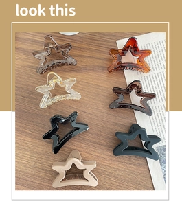 Set of seven matte star-shaped hair claws in black, beige, amber, and coffee tones