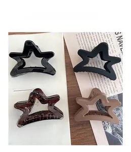 Detail of star-shaped hair claws in matte and glossy finishes for women's hairstyles