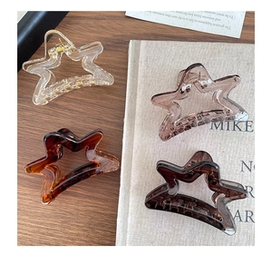 Detail view of four frosted star-shaped hair claws in transparent assorted colors