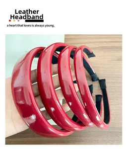 Detail of red faux leather headbands with non-slip inner teeth and thick glossy texture