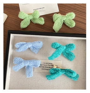 Macro detail of high quality mohair knitted bow hair clips in pastel candy colors