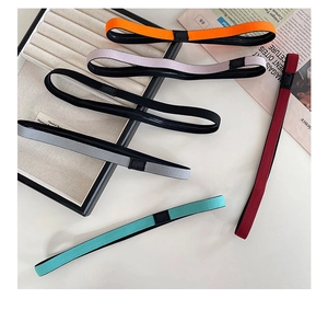 Flat lay of colorful elastic yoga headbands in orange, purple, and gray knit fabrics