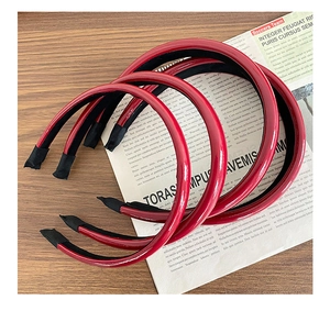 Close-up of five shiny red faux leather headbands with anti-slip inner texture