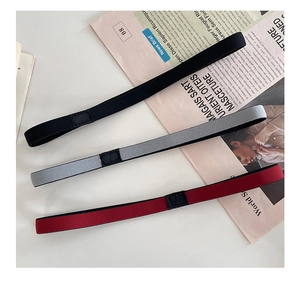 Close-up of three elastic non-slip sport headbands in black, grey, and burgundy colors