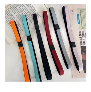 Close-up of colorful non-slip elastic yoga headbands on a stylish newspaper background
