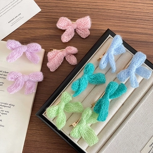 Cute knitted wool bow hair clips in pastel candy colors with golden metal hairgrips