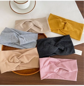 Detailed knit texture of multi-colored cotton yoga headbands with cross twist design