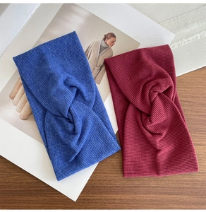 Close-up of ribbed cotton sports headbands in blue and burgundy with cross knot detail