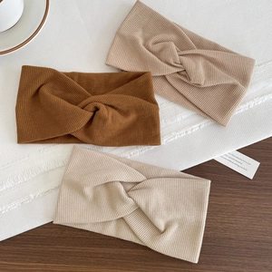 Three-pack cotton ribbed yoga headbands with cross-knot design in neutral earth tones