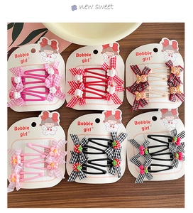 Detail view of colorful bow hair clips set with plaid patterns and cute resin charms