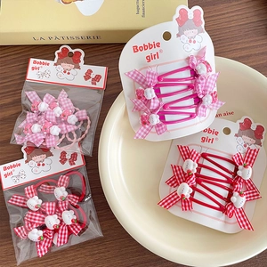 Cute cartoon girls hair clip set with pink plaid bows and rabbit charms in a cream bowl