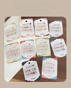 Macro view of assorted 3D cartoon nail stickers for kids in colorful blister packaging