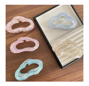 Set of 5 pastel pearlescent wave hair claws in pink purple blue green and cream on wooden table