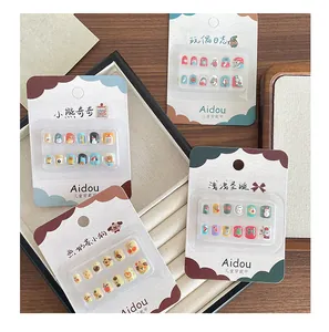 Close-up of colorful 3D cartoon nail art set for kids with bear and dog patterns