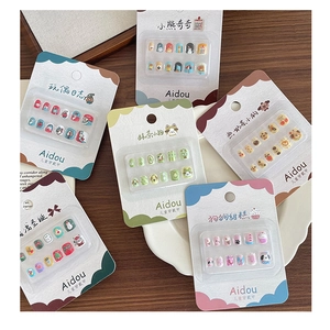 Close-up of colorful cartoon press-on nails for girls featuring cute animal patterns