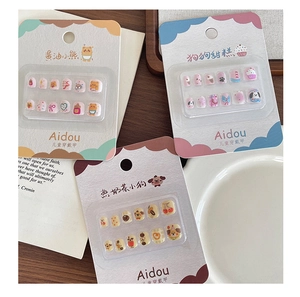 Detailed view of three cartoon themed kids' press-on nail sets with cute animal patterns