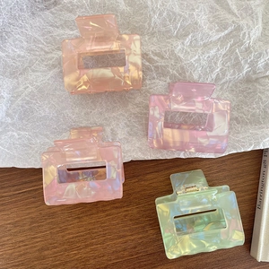 Iridescent square claw clips in peach pink, lilac, and mint green with marble texture