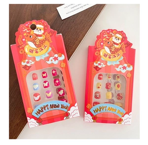 Detail view of festive New Year press-on nails for girls featuring cute cartoon patterns