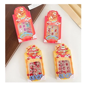 Detailed view of kids' New Year press-on nails set with festive Chinese zodiac patterns