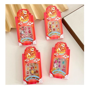 Close-up of four festive New Year themed press-on nail sets for kids with cartoon patterns