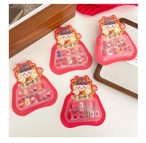 Close-up of children's colorful nail art set featuring festive cartoon patterns and sequins