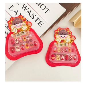 Detail of red cartoon press-on nails with rabbit and lucky characters for New Year