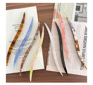 Detailed view of handmade acetate hair sticks in various vintage patterns and marble textures