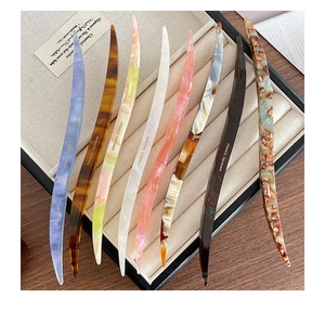 Detail showing eight French vintage acetate hair sticks with marble and tortoiseshell patterns