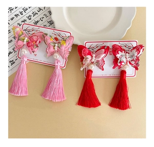 Close-up of Chinese style butterfly hair clips with pearl embroidery and long tassels