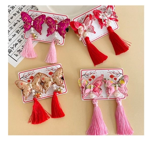 Detail of embroidered butterfly hair clips with pearls, bells and tassels for Hanfu outfits