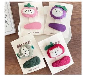 Detail of handmade fabric hair clips for girls featuring cute animal embroidery and BB clips