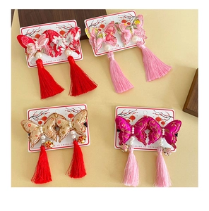 Detailed embroidery on butterfly hair clips with pearls and long tassels in four colors