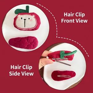 Handmade fabric children hair clips featuring red apple embroidery and quilted oval design