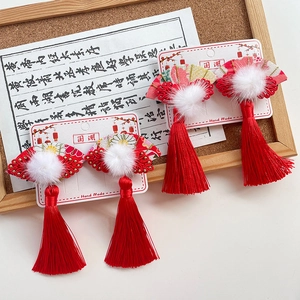 Traditional Chinese folding fan hair clips with red tassels and white fluffy pom-poms
