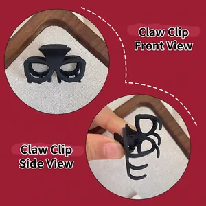 Pince à cheveux noire mate en forme de lunettes pour queue de cheval, vues de face