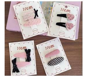 Set of four handmade pink tweed and velvet hair clips for girls on display card