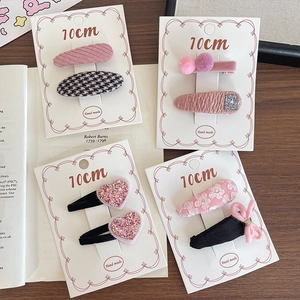 Pink fabric hair clips for girls featuring cute knit patterns and bow decorations