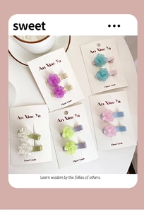 Detail view of colorful 3D resin flower hair clips in five pastel colors with satin bases