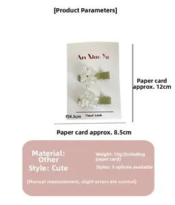 Detail view of two sweet floral hair clips on display card with exact size measurements