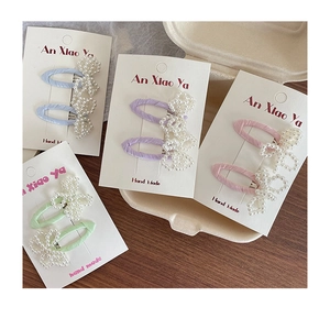 Detailed macro view of handmade macaron pearl bow hair clips in pastel colors
